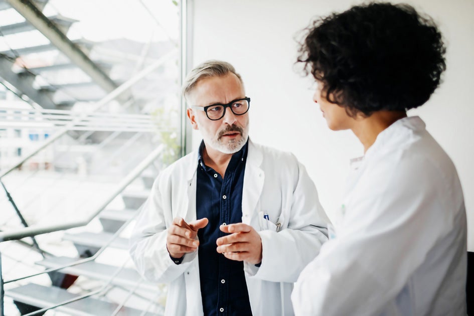 Two Doctors talking in a concentrated manner