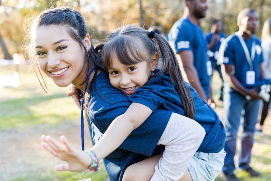 Community member giving a piggy-back ride